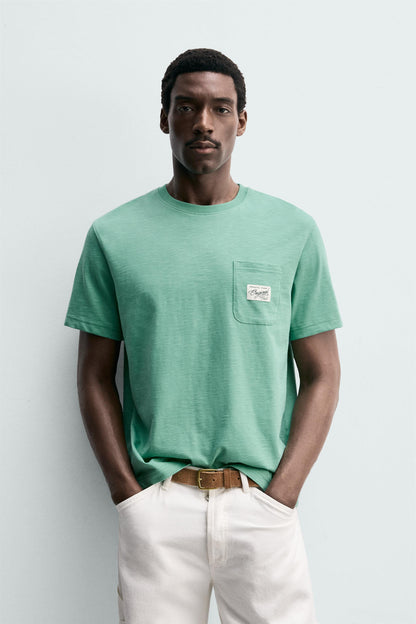 T-SHIRT REGULAR FIT COM BOLSO E REMENDO