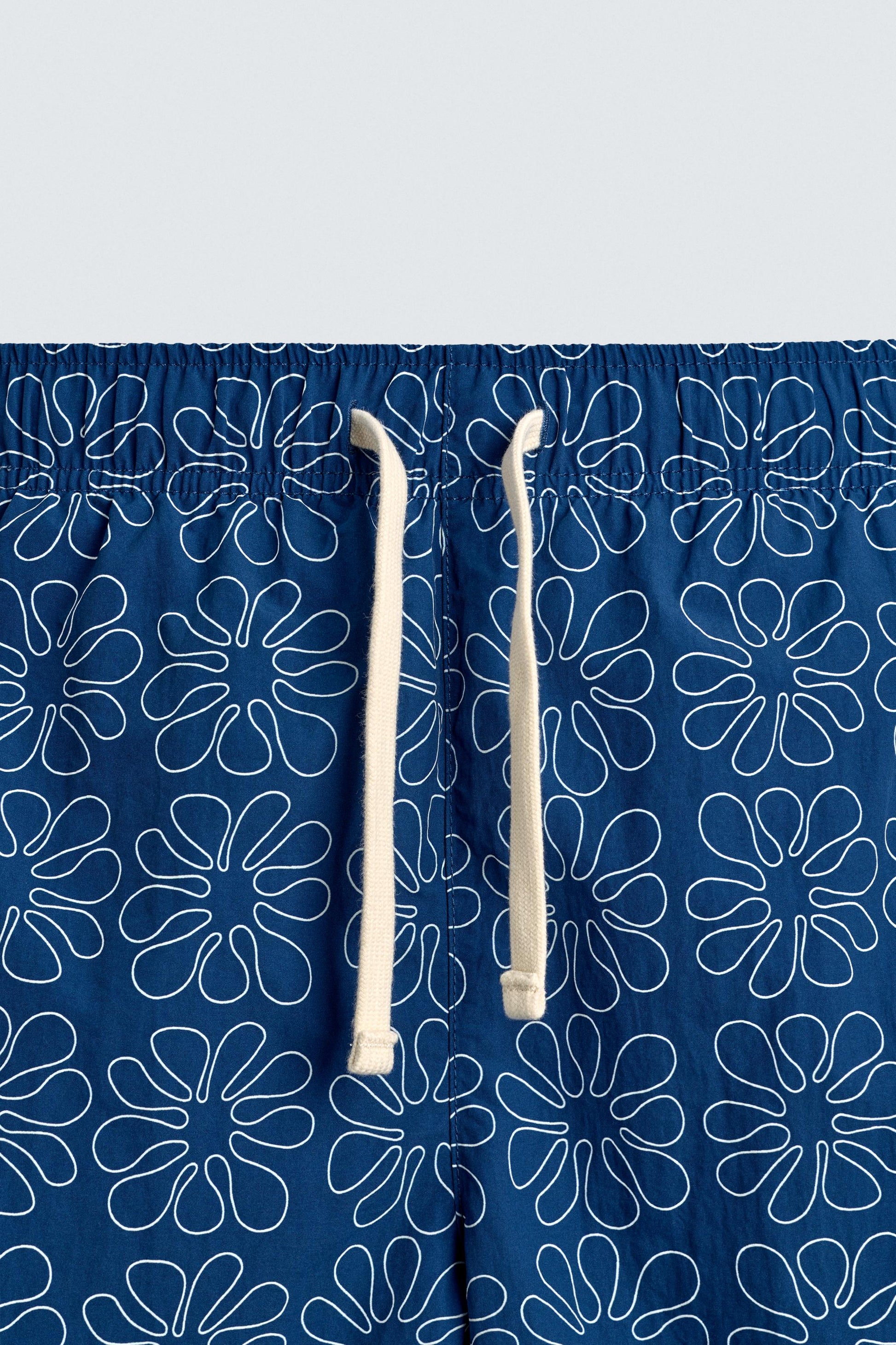 CALÇÕES DE BANHO COMPRIDOS COM ESTAMPADO FLORAL