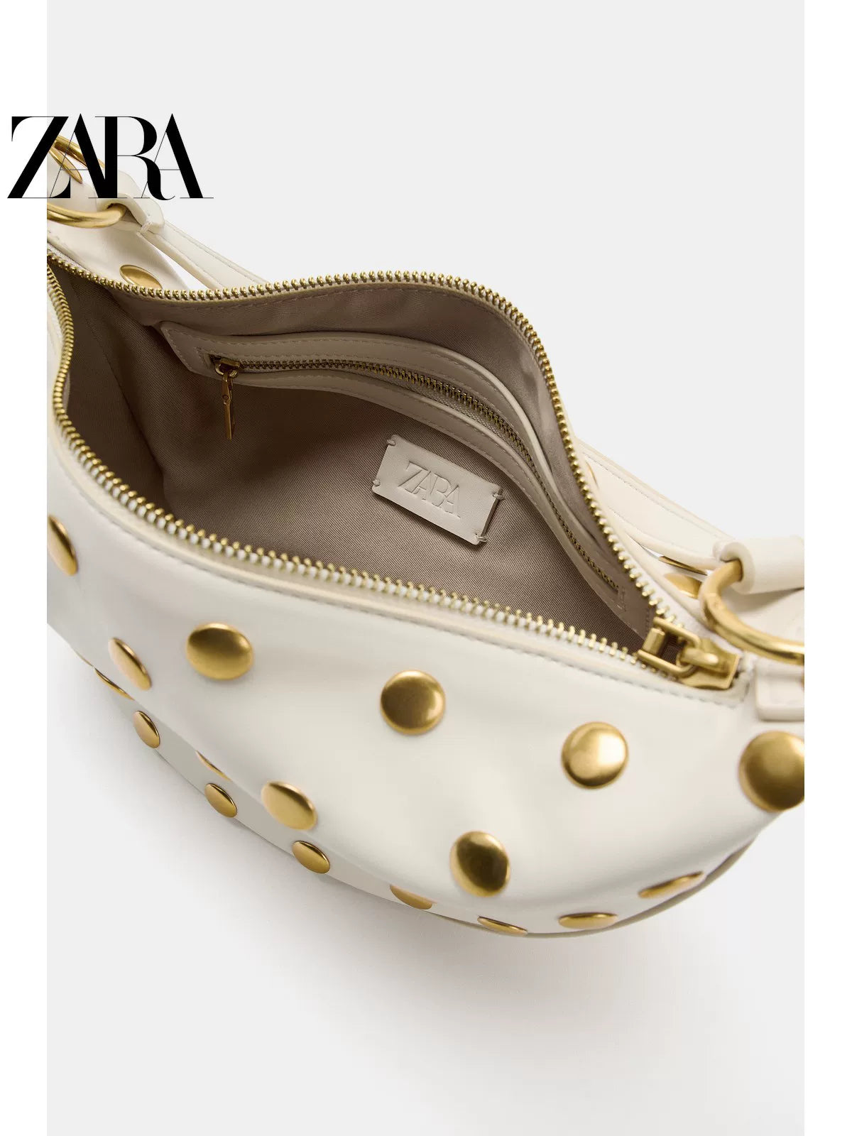 Bolsa feminina ZARA, lançamento da coleção verão 2026, com detalhes em rebites e zíper com argola metálica, modelo ombro, código 6094810 850.