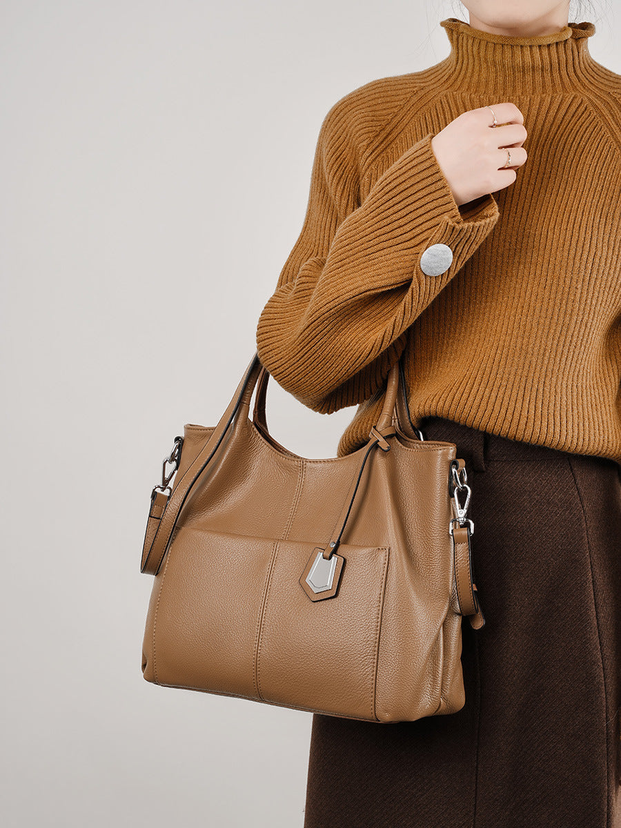 Malas de pele genuína para mulheres, novas malas de ombro simples para primavera/verão 2026, malas tote de grande capacidade feminina, malas para mães de meia-idade, malas crossbody